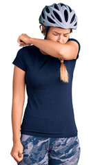 Beautiful caucasian woman wearing bike helmet feeling unwell and coughing as symptom for cold or bronchitis. health care concept.