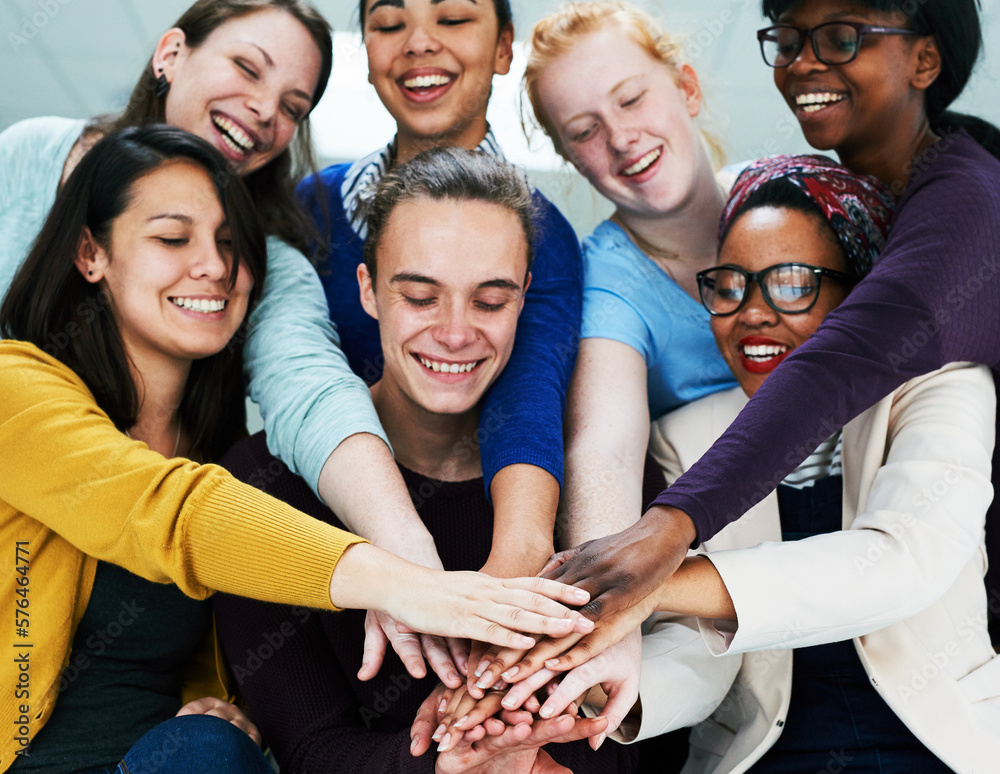Poster together we can complete any task. low angle shot of a group of coworkers stacking their hands on to