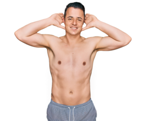 Handsome young man wearing swimwear shirtless smiling cheerful playing peek a boo with hands showing face. surprised and exited