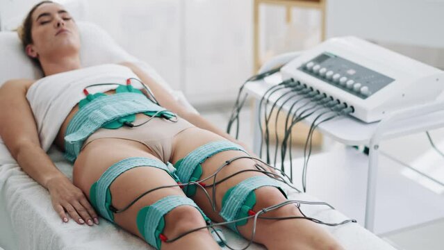 Video of beautiful woman with laser lipo equipment in her body in medicine salon. 