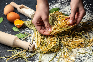 Female chef making homemade pasta with flour and eggs. process of making cooking homemade pasta