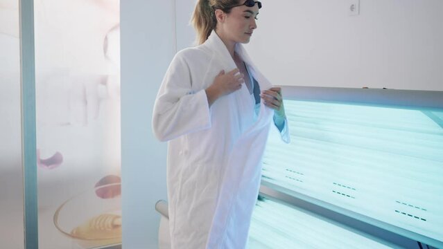 Video of beautiful woman having tanning skin treatment in a solarium