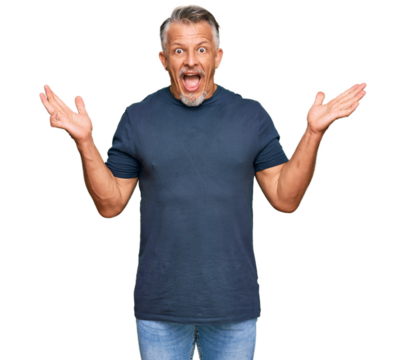 Middle age grey-haired man wearing casual clothes celebrating crazy and amazed for success with arms raised and open eyes screaming excited. winner concept - Powered by Adobe