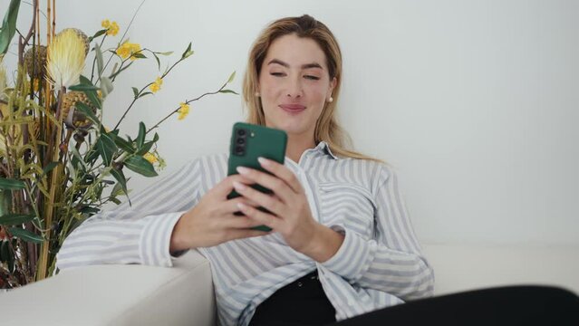 Video of beautiful woman using her mobile phone in the waiting room