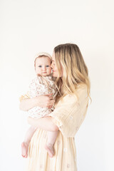 mother and baby daughter with floral dress and bonnet