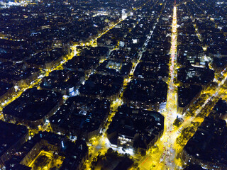 Aerial view of illuminated Eixample district in Barcelona at night, Spain..