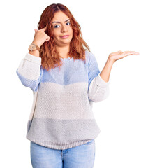 Young latin woman wearing casual clothes confused and annoyed with open palm showing copy space and pointing finger to forehead. think about it.