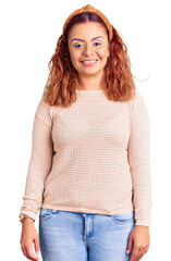 Young latin woman wearing casual clothes and diadem with a happy and cool smile on face. lucky person.