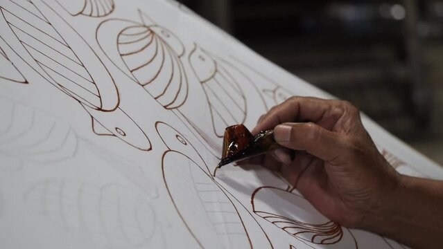 Making batik tulis Solo.  The technique of making batik by writing using a canting tool. Canting consists of nyamplung, cucuk, gagang or handles made of copper, bamboo and wax