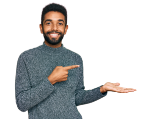 Young african american man wearing casual clothes amazed and smiling to the camera while presenting with hand and pointing with finger.