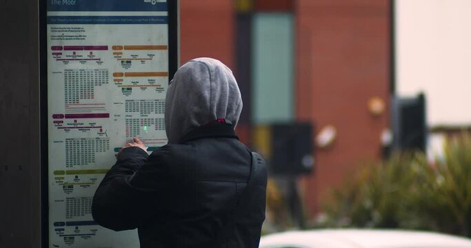 Man looking at bus times
