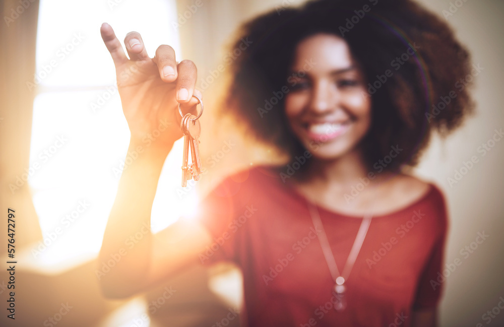 Wall mural New beginnings.... Portrait of a young woman holding up the keys to a new home.