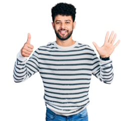 Young arab man with beard wearing casual striped sweater showing and pointing up with fingers number six while smiling confident and happy.