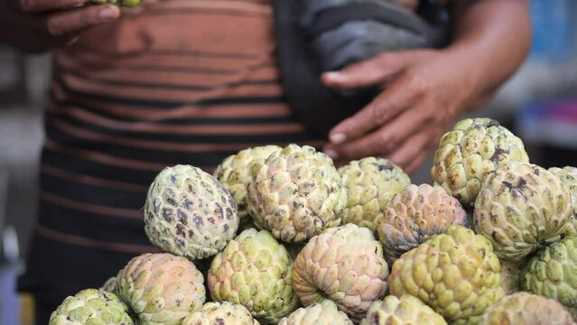 Selective focus Sugar-apple fruit (Annona squamosa) on table for sell in market of the tropical fruit that also known as sweetsop or custard apple.