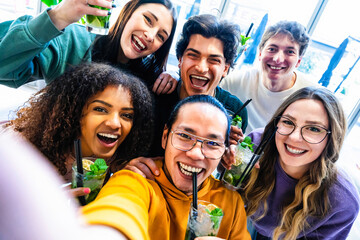 Group of multiracial friends taking selfie shot at bar with mojito drink-Young happy people having...
