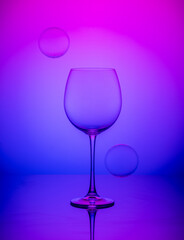wine glass with balls on a blue-pink background