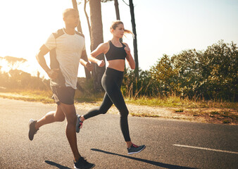 In the fitness game for the long run. Shot of a fit young couple going for a run outdoors.