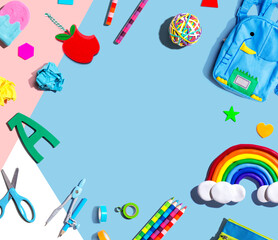 School supplies with a rainbow - overhead view - flat lay