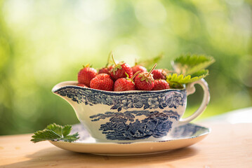 Strawberries in white jug,  sunny day in june, eating fruits in the garden, sparking bokeh