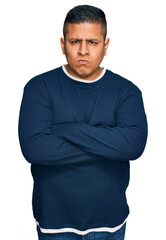 Obraz premium Young latin man wearing casual clothes skeptic and nervous, disapproving expression on face with crossed arms. negative person.