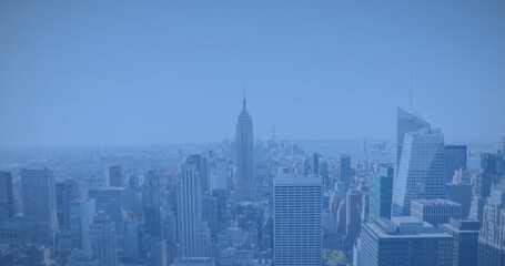 Image of modern cityscape over blue background