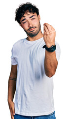 Hispanic young man with beard wearing casual white t shirt doing italian gesture with hand and fingers confident expression