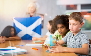 Kids learning together about scotland in geography class