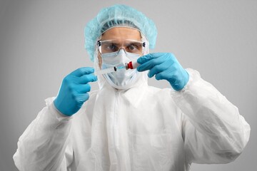 Young doctor with test tube in hand