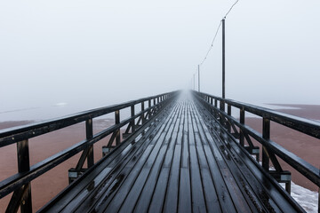 Long pier on a foggy morning