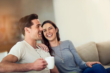 Filling their home with love and laughter. Shot of a happy young couple relaxing together at home. - Powered by Adobe