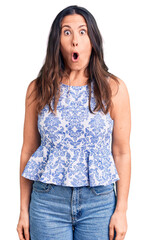 Young beautiful brunette woman wearing casual t-shirt afraid and shocked with surprise expression, fear and excited face.