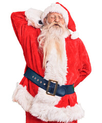 Old senior man with grey hair and long beard wearing traditional santa claus costume suffering of neck ache injury, touching neck with hand, muscular pain