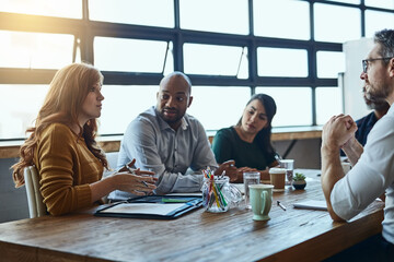 Everyones opinion gets heard. Cropped shot of a group of business colleagues in the office having a...
