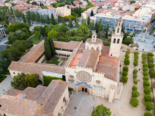 Aerial view of monumental Benedictine Monastery in Spanish town of Sant Cugat .