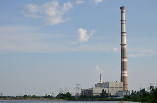 CHP building, power lines and a tall chimney. air emissions and air pollution. abandonment of thermal power plants in favor of the environment, transition to green energy