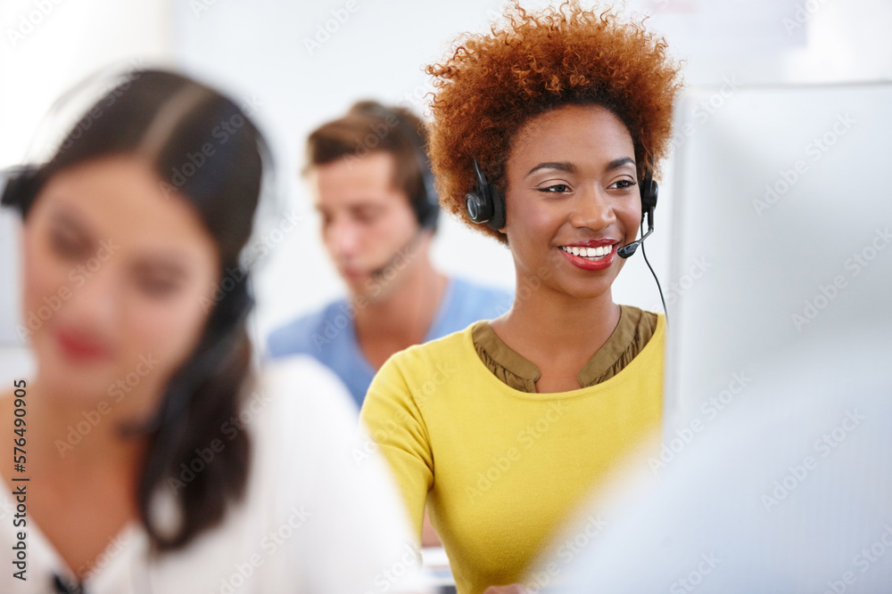 Poster theyre always available. cropped shot of colleagues working in a call center.