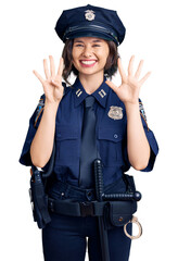 Young beautiful girl wearing police uniform showing and pointing up with fingers number nine while smiling confident and happy.