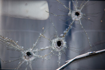 Bullet holes on windshield old car