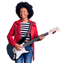 Obraz premium Young african american woman playing electric guitar looking positive and happy standing and smiling with a confident smile showing teeth