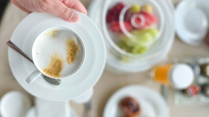 hand holding a cup of coffee, breakfast 