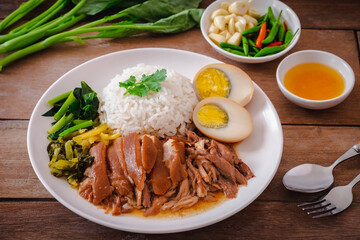 Stewed pork leg with boiled egg and rice on plate