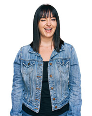 Fototapeta premium Young hispanic woman wearing casual clothes winking looking at the camera with sexy expression, cheerful and happy face.