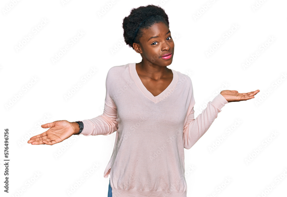 Poster Young african american girl wearing casual clothes clueless and confused expression with arms and hands raised. doubt concept.