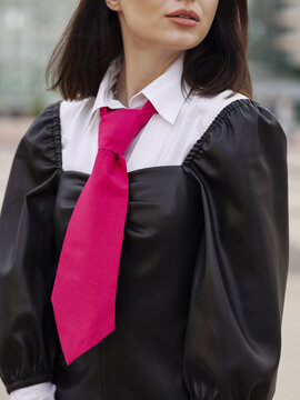 Pink fashion designer female tie cravat on a model women. Business women's necktie close up. Formal official suite for women