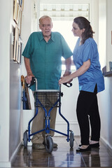 Fototapeta na wymiar When the going gets tough, Ill help you get going. Shot of a female nurse assisting her senior patient whos using a walker for support.