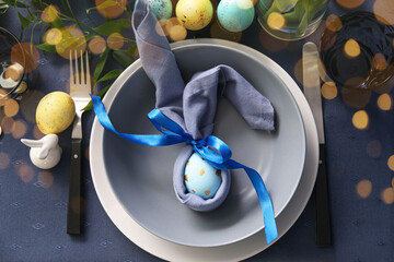 Festive table setting for Easter celebration on dark blue background