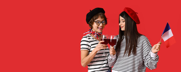 Young lesbians with flag of France and wine on red background with space for text