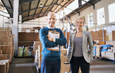 Your shipment left the warehouse today. Portrait of two managers standing in a distribution...