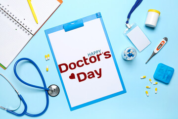 Clipboard with text HAPPY DOCTORS DAY, stethoscope and drugs on light blue background