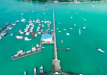 Chalong pier with sailboats and other boats at the sea,Beautiful image for travel and tour website design,Amazing phuket island view from drone seascape landscape,Summer day - obrazy, fototapety, plakaty